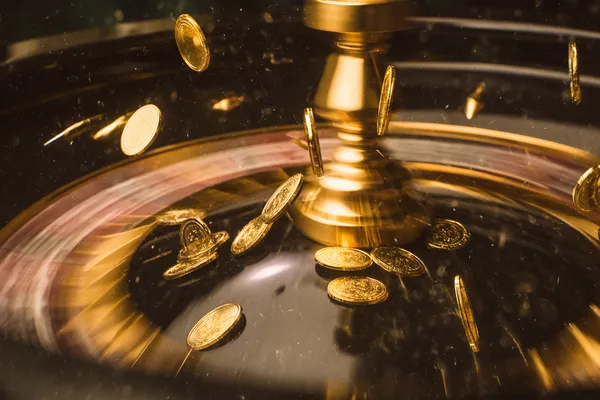 A woman smiling while playing online games on her laptop, surrounded by neon casino elements, showcasing 777ZK’s diverse game collection.